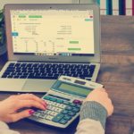 Woman using calculator group insurance