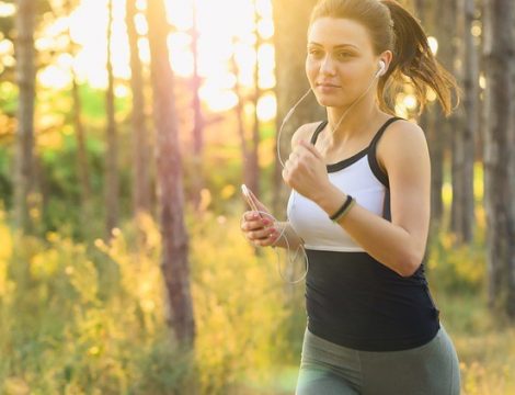 Lady Jogging in Park with Headphones shedding pounds